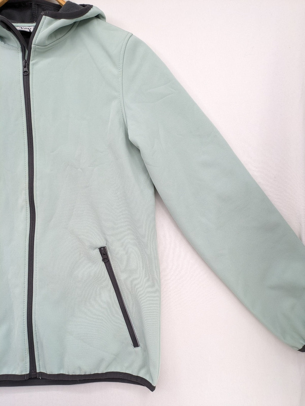YFK outdoor jacket mint green softshell with dark grey fleece lining and hood.