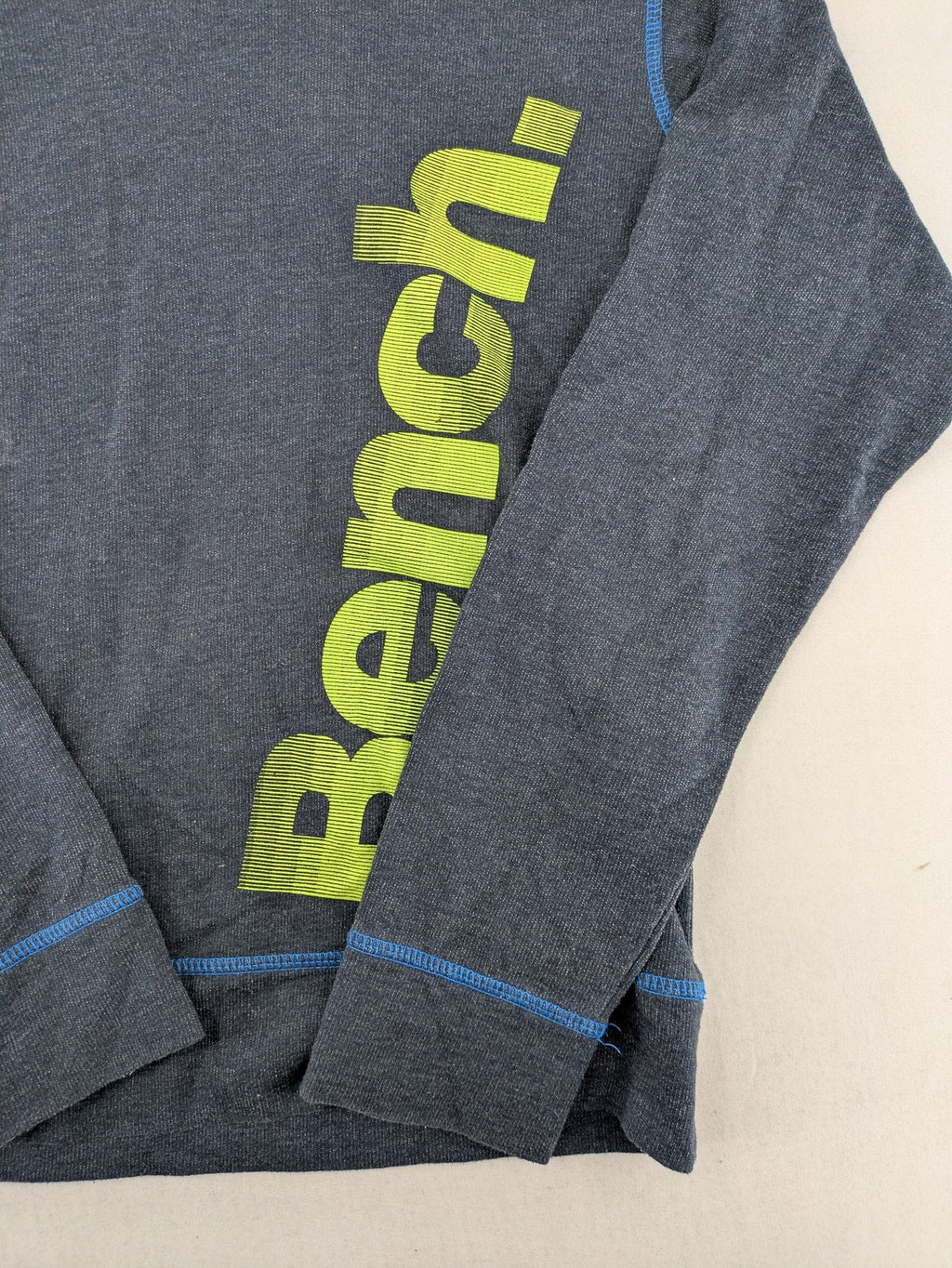 Bench hoodie dark grey with neon green logo and blue contrast stitching.