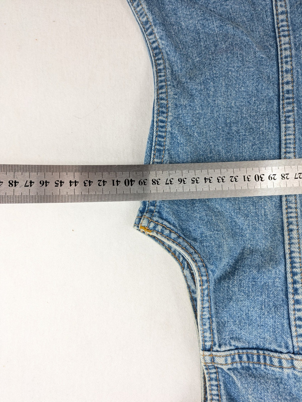 s.Oliver blue denim vest with button closure, pointed collar, and breast pockets.