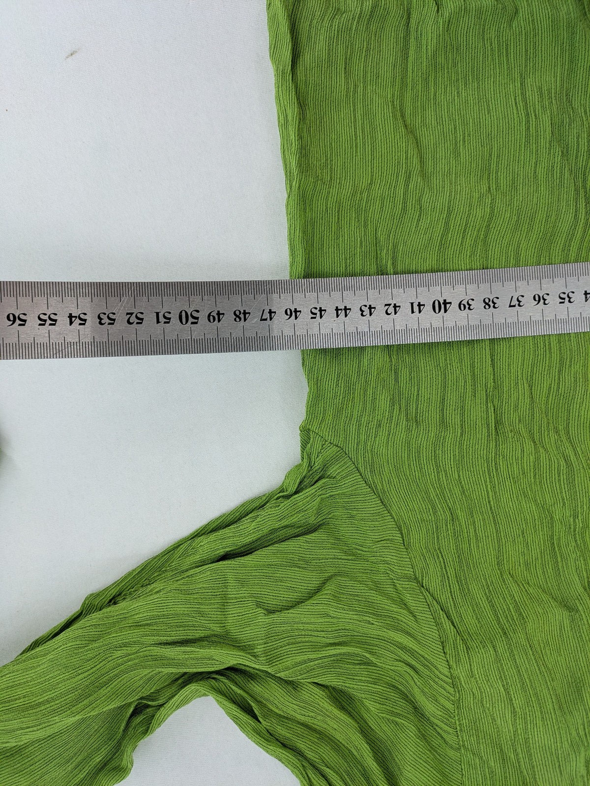 Expressions green blouse with V-neck, button front, and crinkle texture.