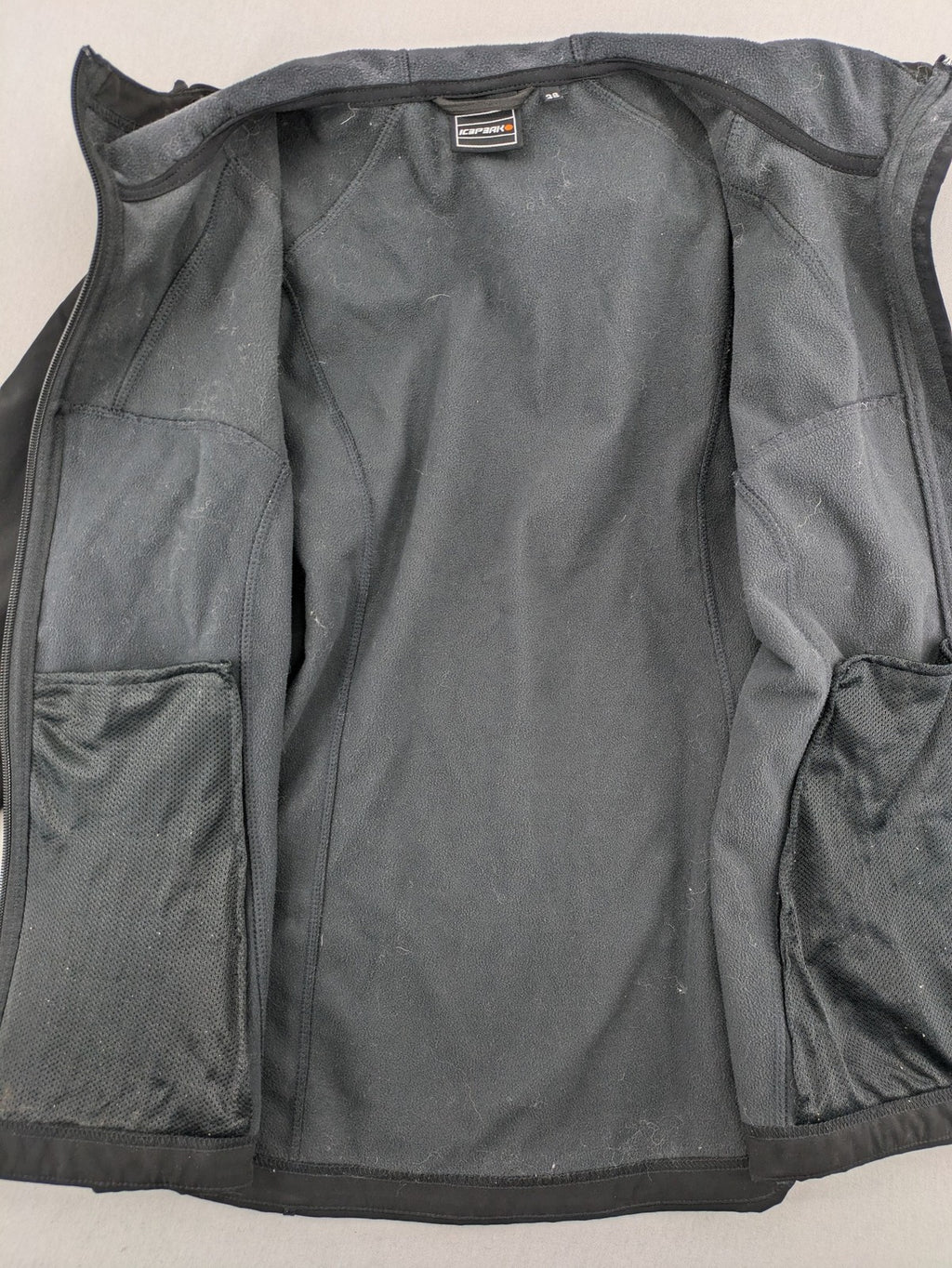 Icepeak black softshell jacket with fleece lining, adjustable hood, and zippered pockets.