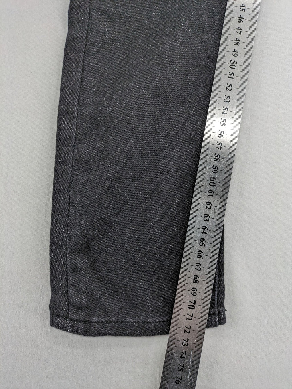 Skinny black straight jeans with distressed details and logo, made from durable denim.