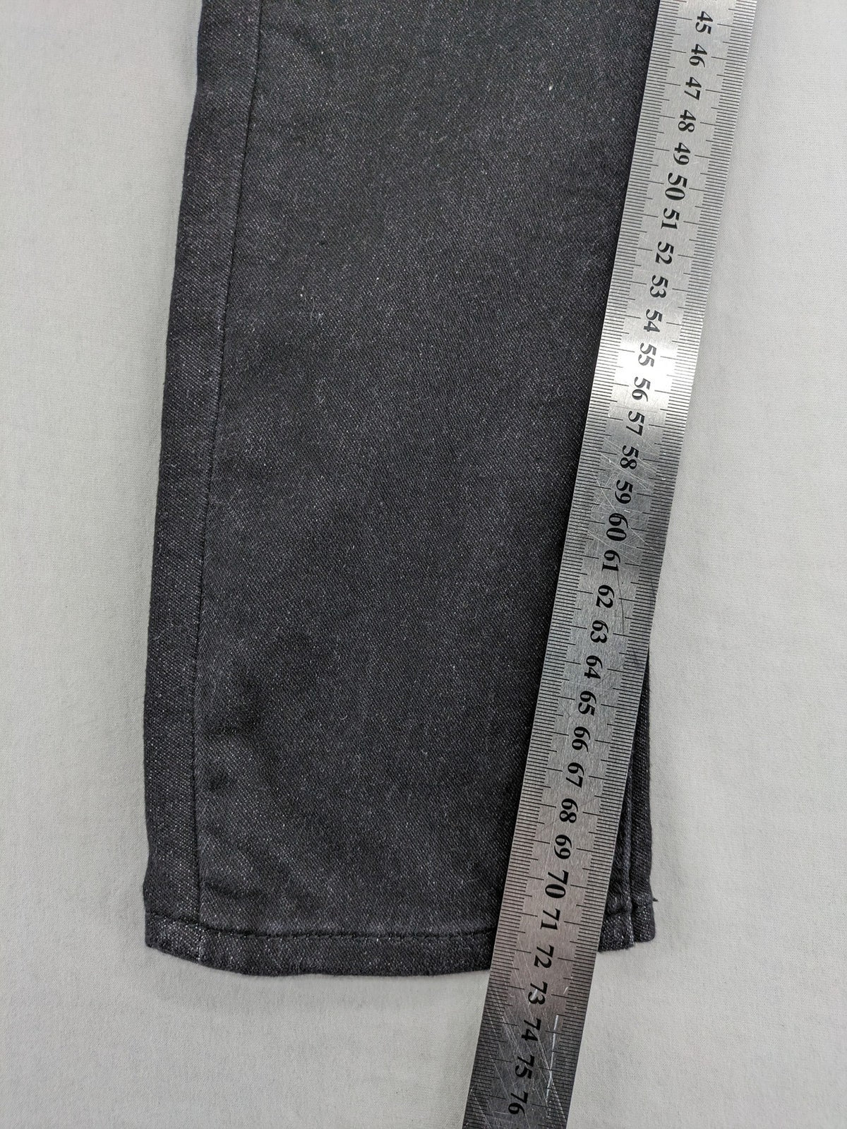 Skinny black straight jeans with distressed details and logo, made from durable denim.