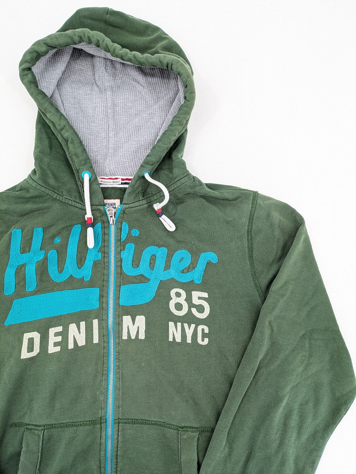 Tommy Hilfiger Denim green hoodie full zip with large graphic logo and grey waffle lining.