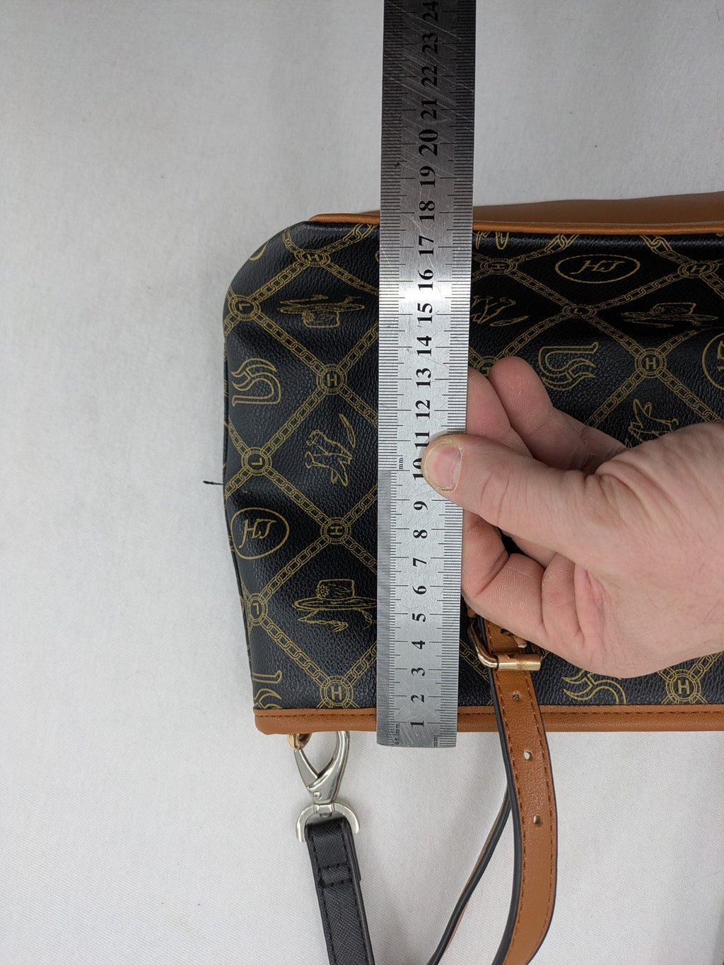 L&H brown and black handbag with monogram pattern and gold accents, versatile shoulder strap.