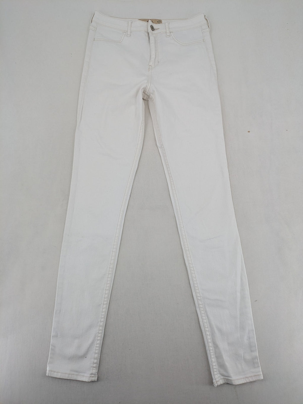 Hollister white super skinny high rise jeans with classic 5-pocket design and zipper closure.