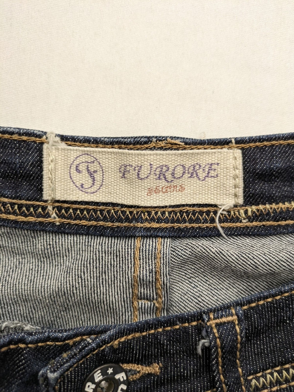Furore blue straight jeans with yellow contrast stitching and zipper details.