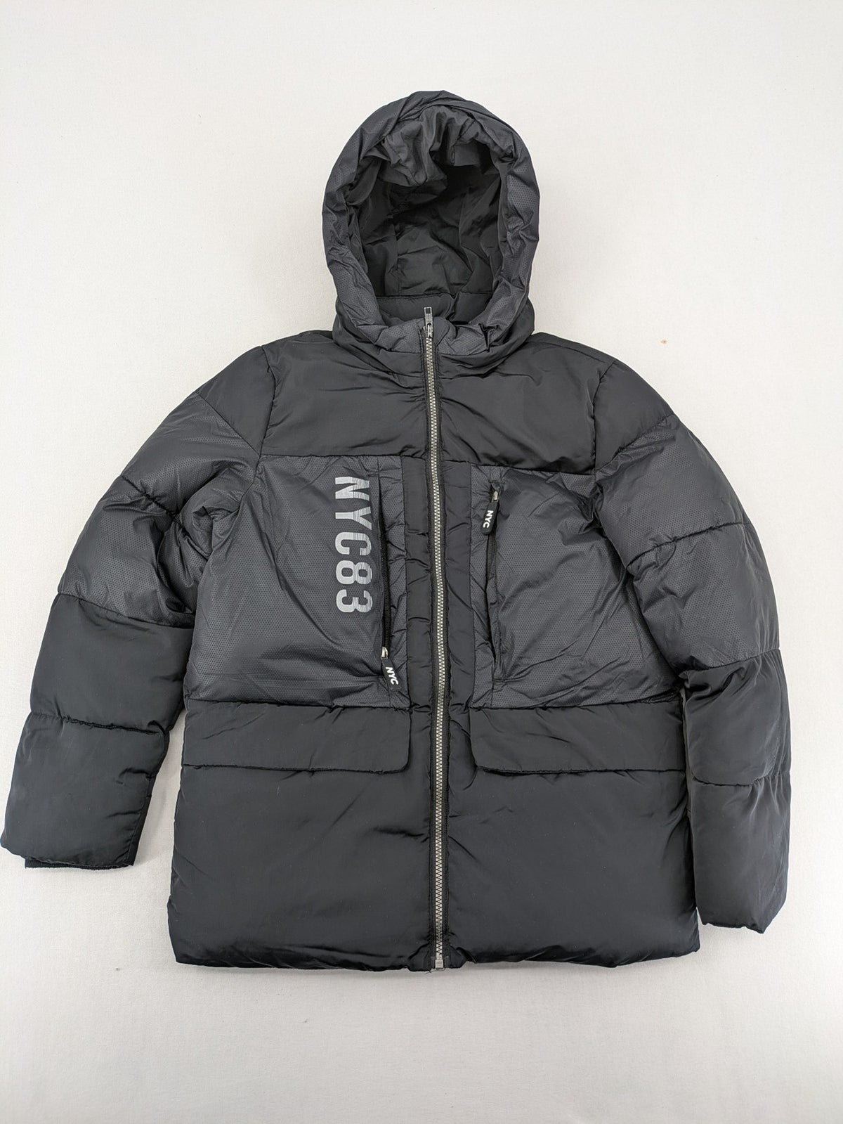 C&A black puffer jacket with NYC83 graphic, hood, and multiple pockets.