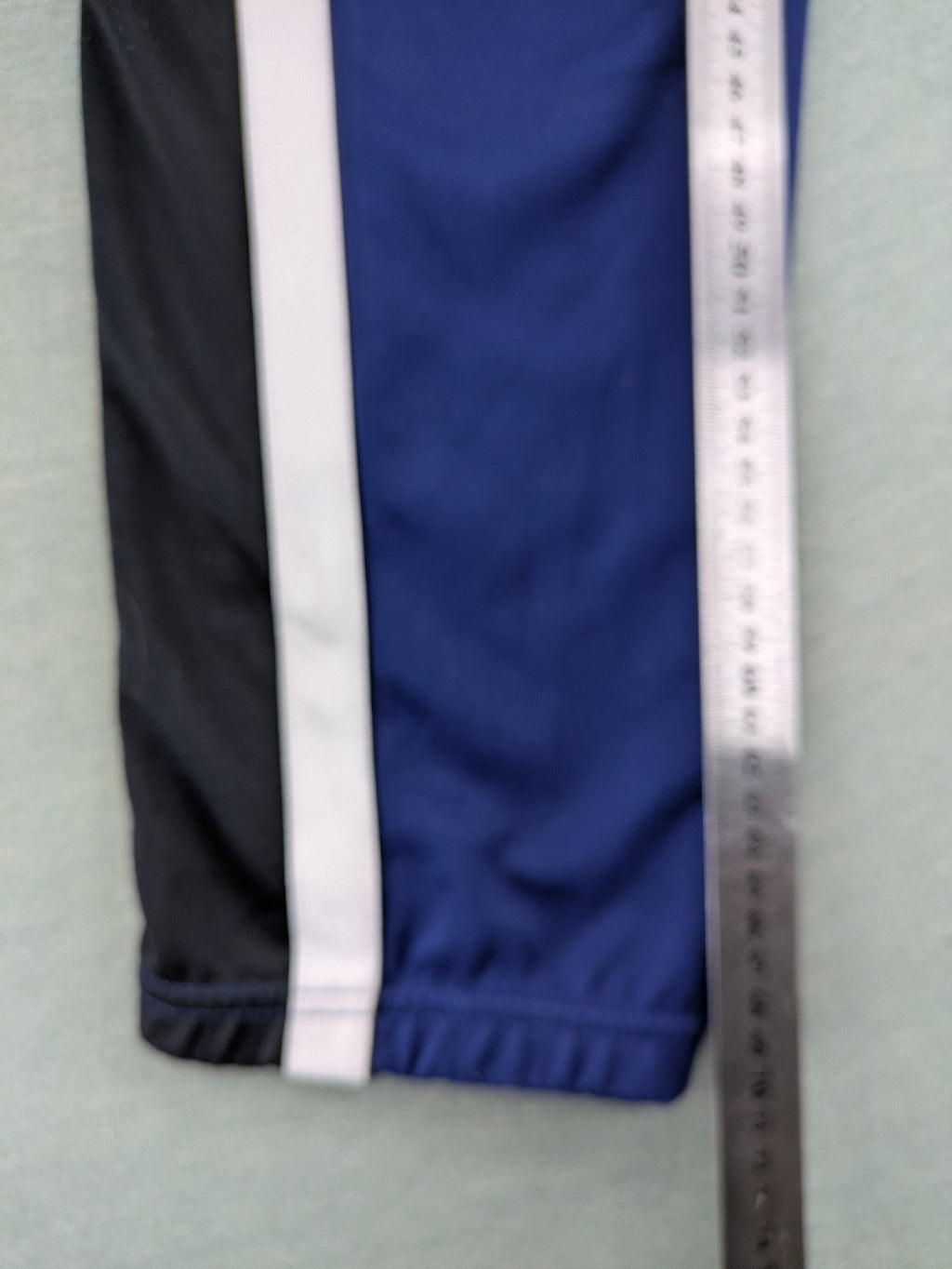 Nike Air blue jogging pants with black and white side stripes, elastic waistband.