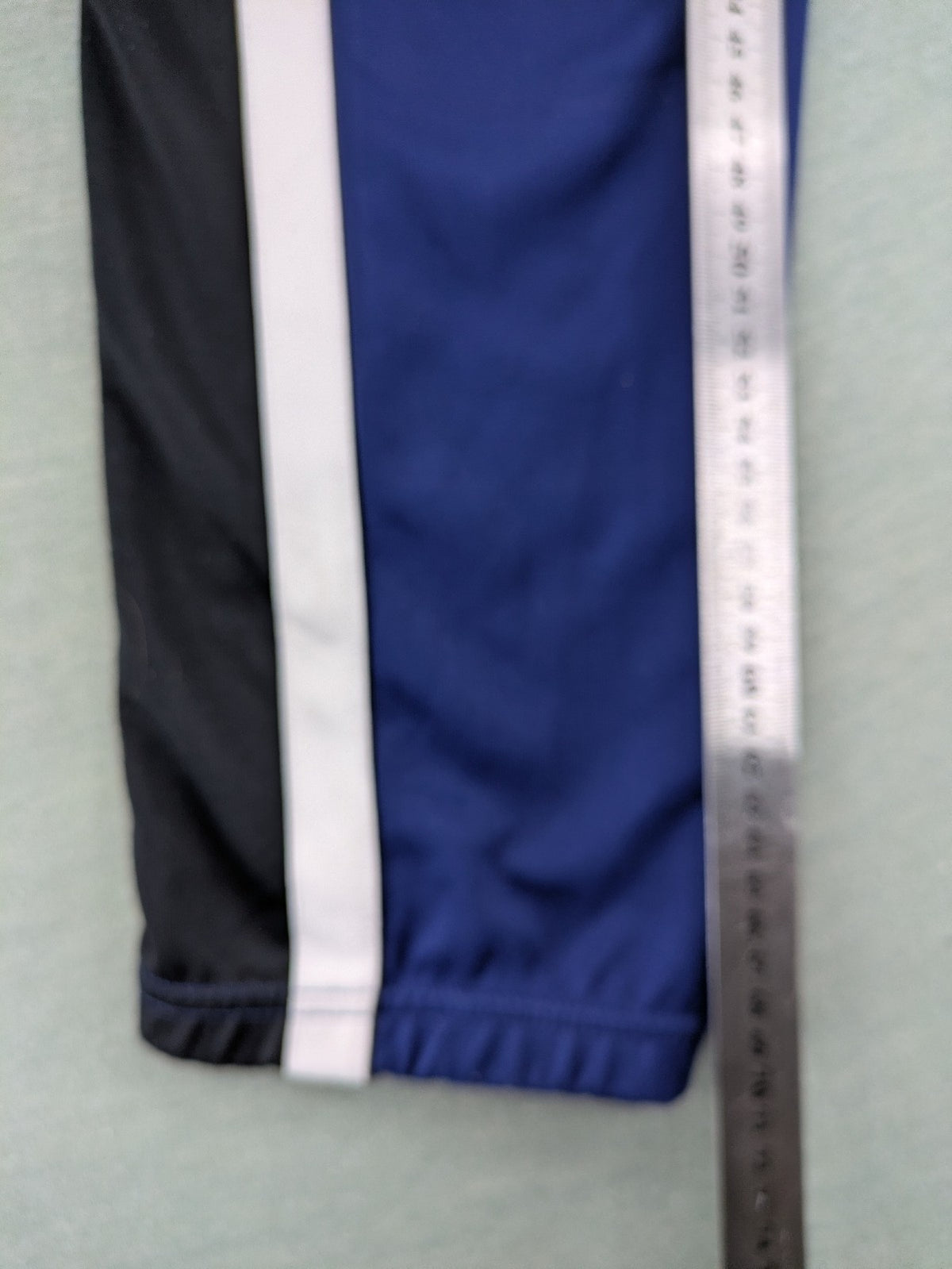 Nike Air blue jogging pants with black and white side stripes, elastic waistband.