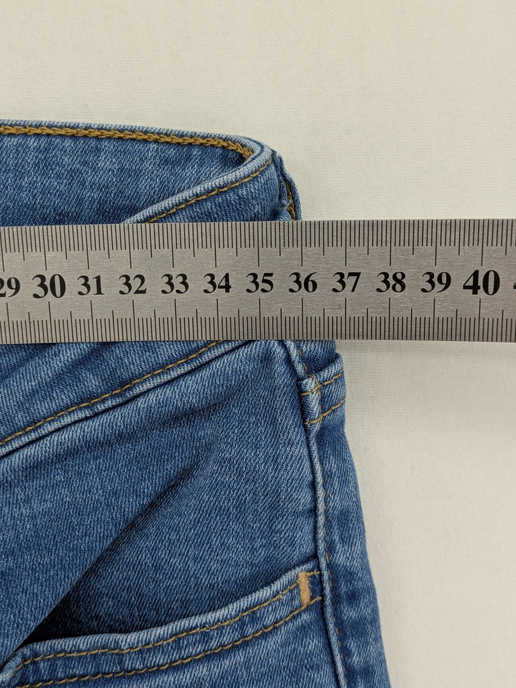 Levi's blue skinny jeans with raw hem, classic five-pocket design, and zip fly.