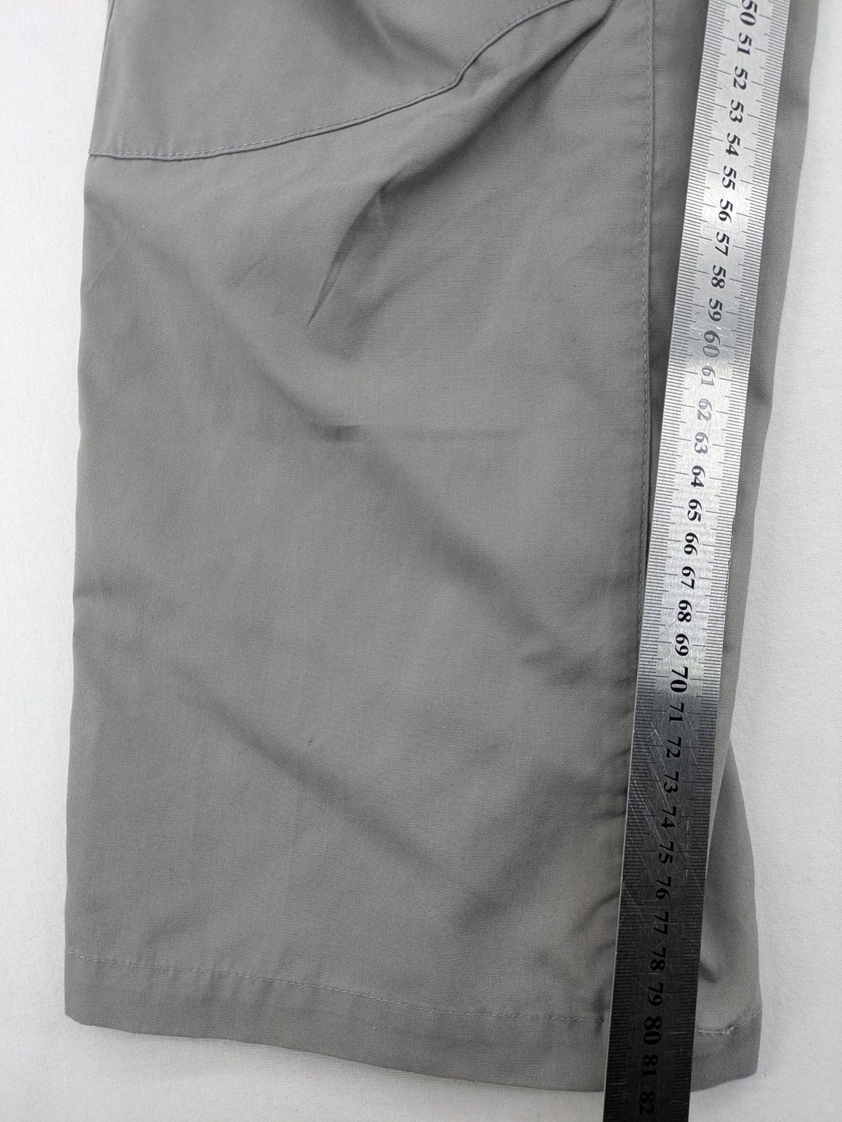 YETI grey cargo pants with multiple zippered pockets and durable material.