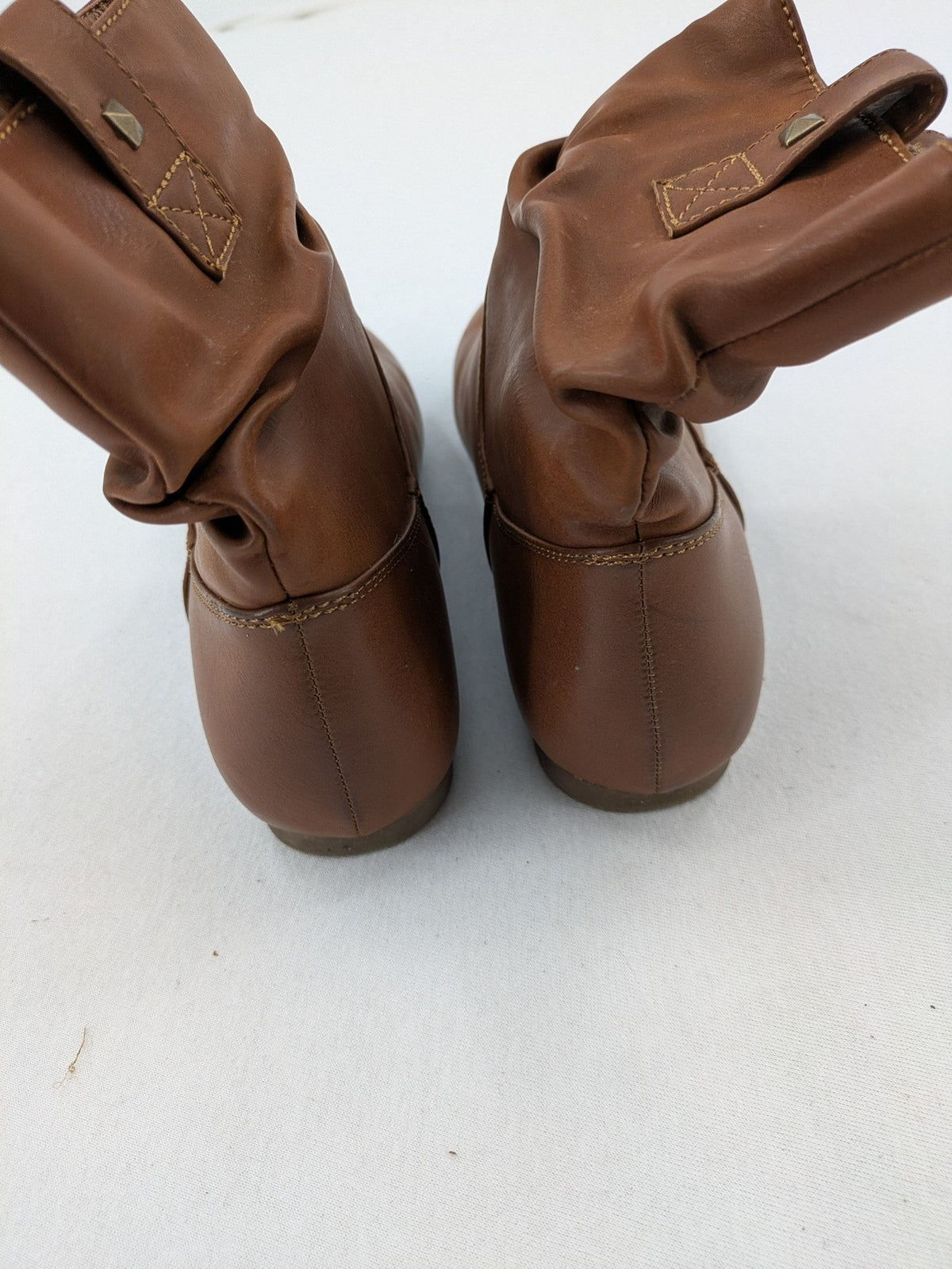 Van Hill brown ankle boots with slouchy design, fold-over cuff, and soft lining.