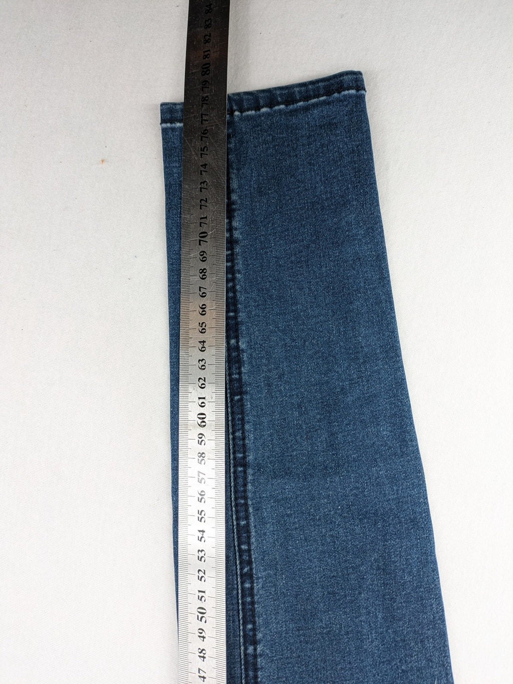 Dust blue skinny jeans with mid-rise waist and classic wash, stretch denim material.