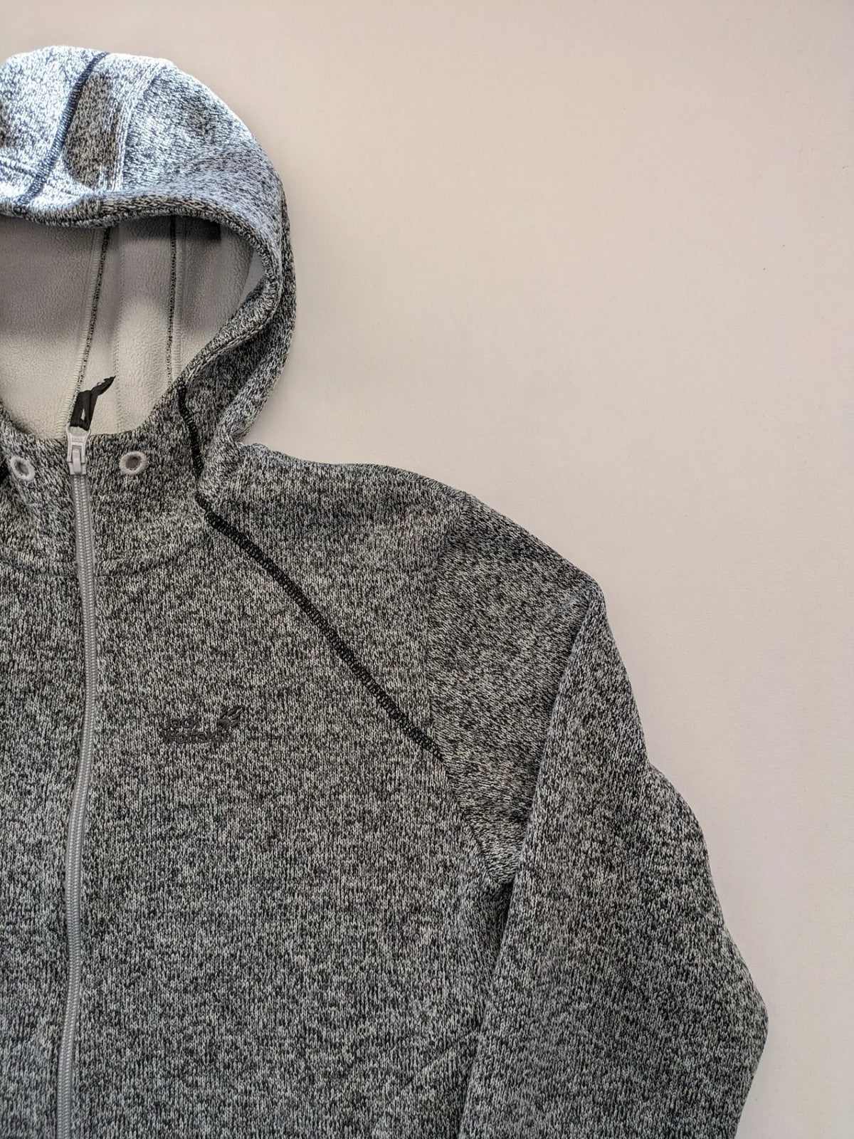 Jack Wolfskin grey fleece jacket with logo detailing and two front pockets.