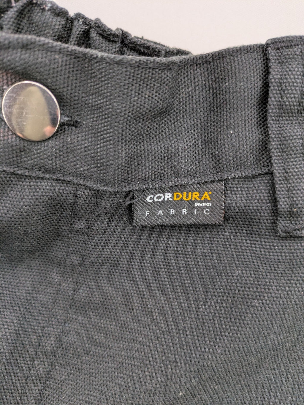 Planam work trousers black canvas with Cordura knee reinforcement and cargo pockets.