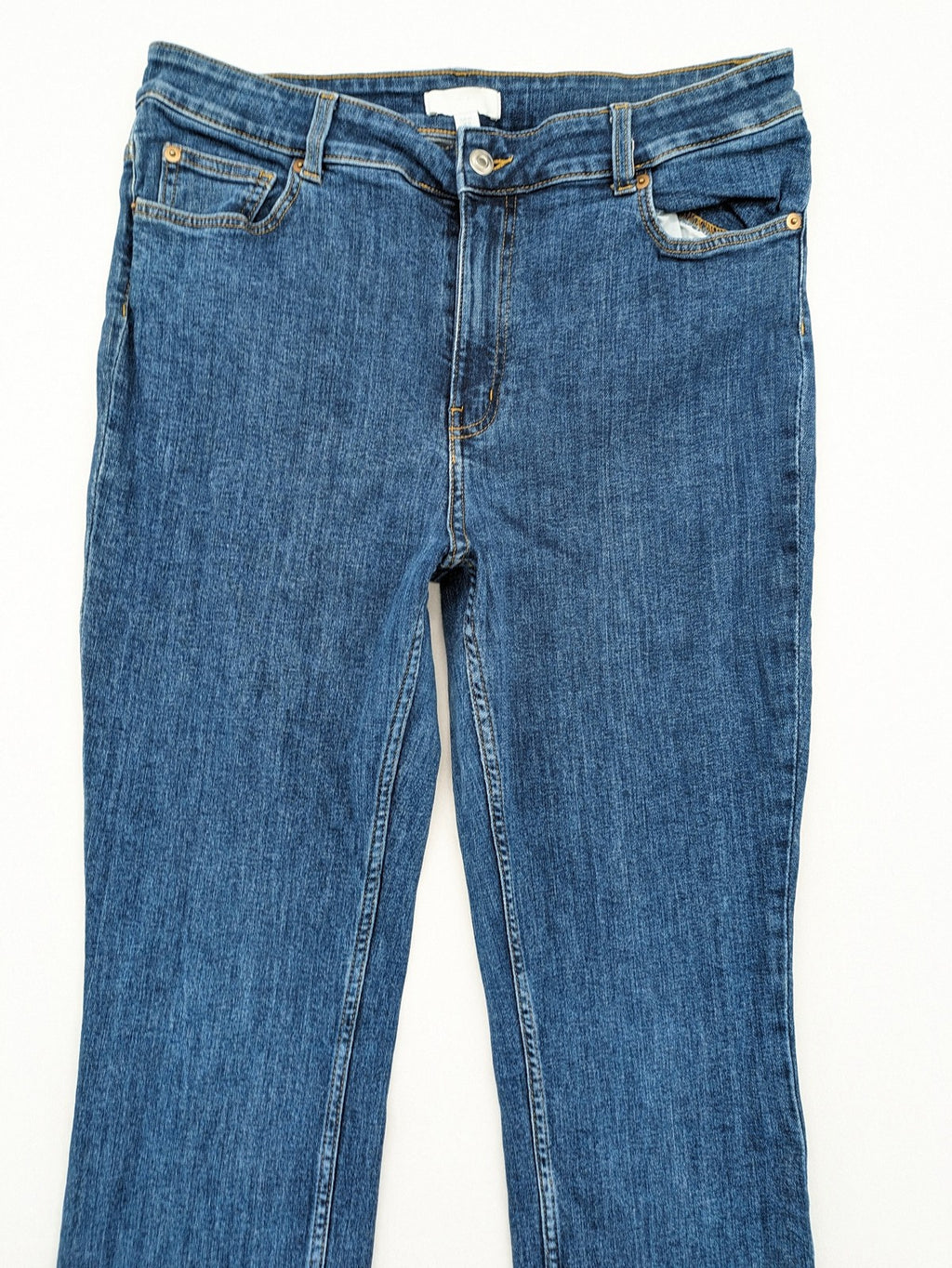 H&M blue skinny jeans with stretch denim and slim fit design.