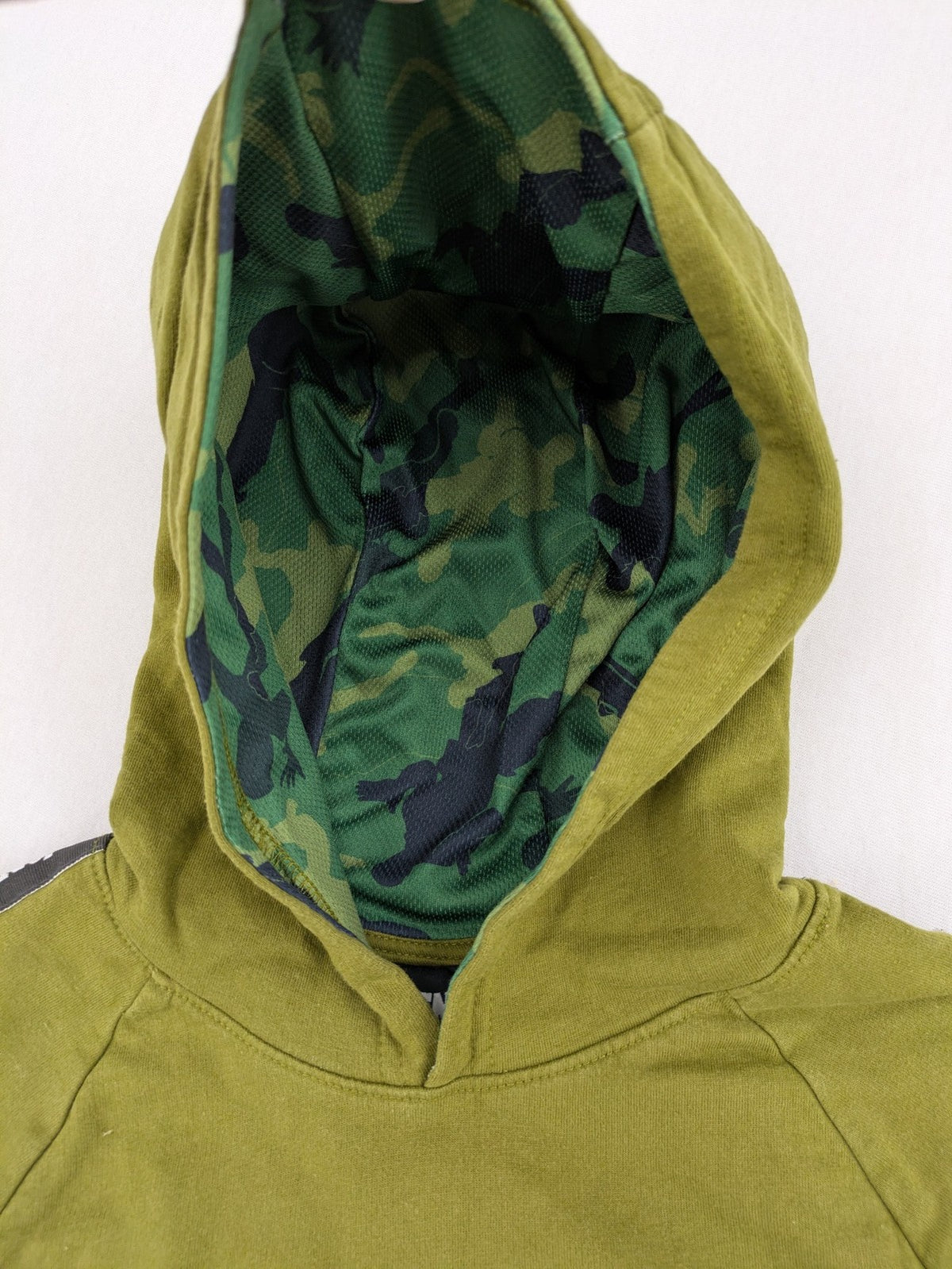 Fortnite green camo hoodie with black logo, contrasting hood, and logo taping on sleeves.