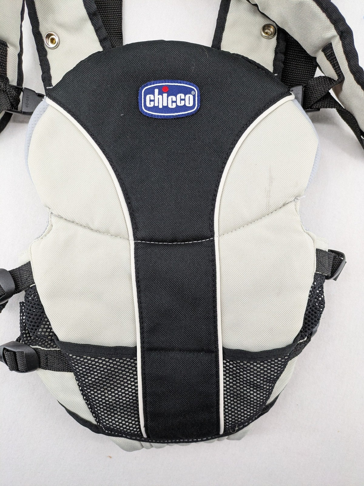 Chicco beige and black baby carrier adjustable straps with padded support for comfort.