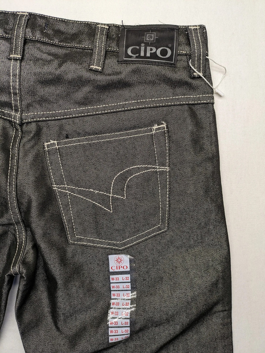 CIPO grey bootcut biker jeans with white contrast stitching and moto-inspired knee pleats.