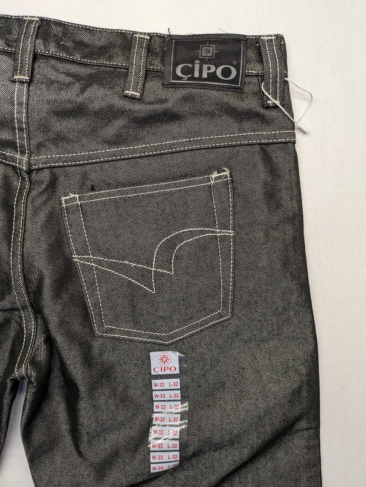 CIPO grey bootcut biker jeans with white contrast stitching and moto-inspired knee pleats.