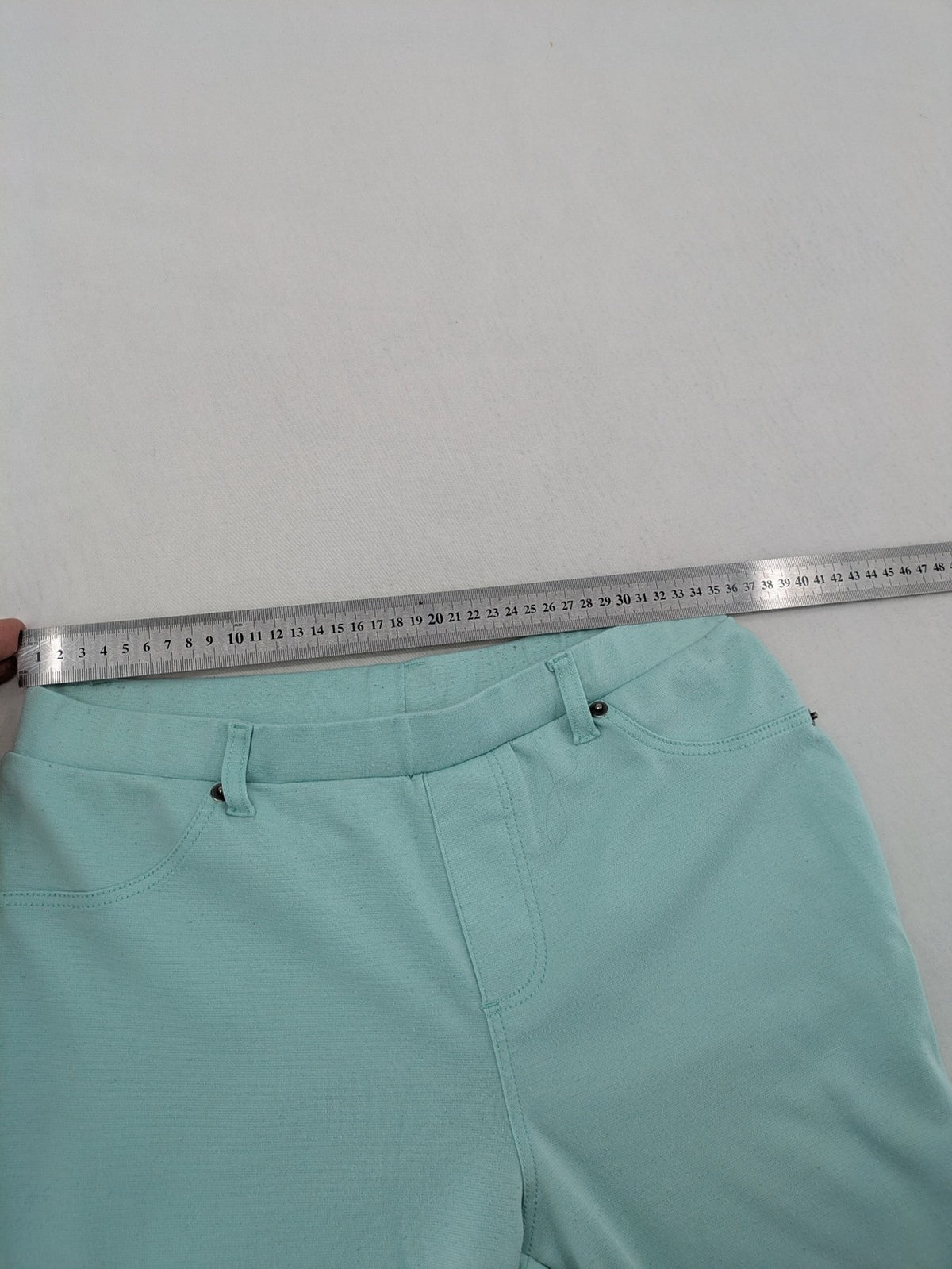 Dito green treggings with pull-on design, front pockets, and belt loops.