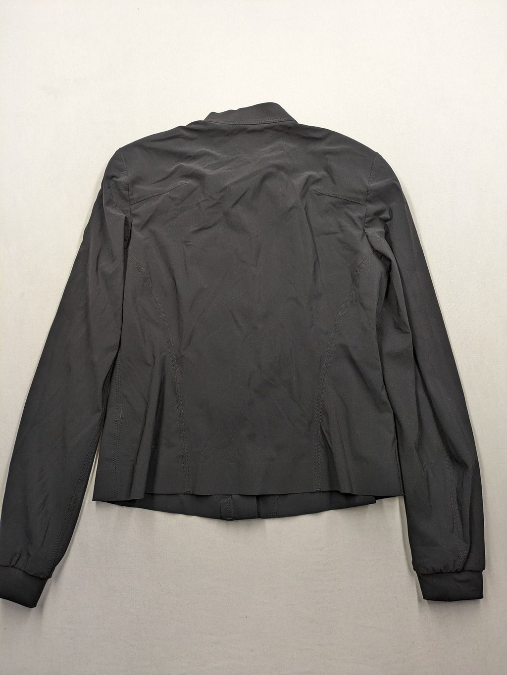 Beate Heymann black biker jacket with asymmetrical front and stand-up collar, stretch material.