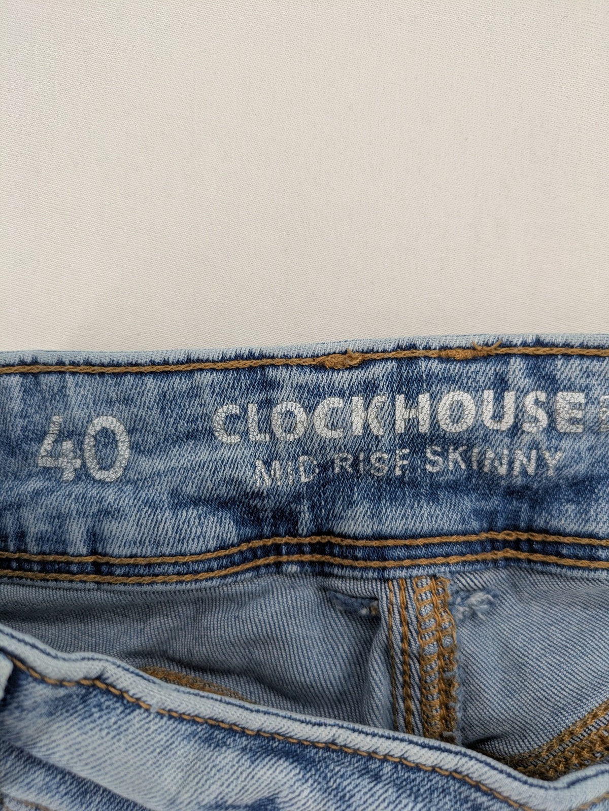 Clockhouse blue skinny jeans with distressed details and frayed hem, mid-rise fit.