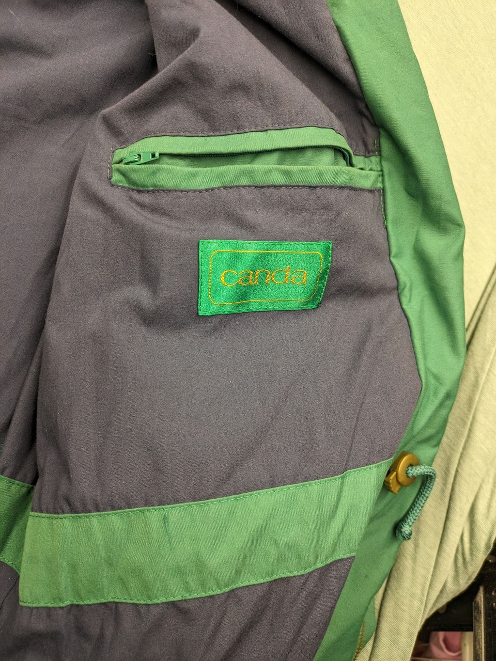 Canda green parka coat with dark lining, multiple pockets, and Micro Membrane technology.