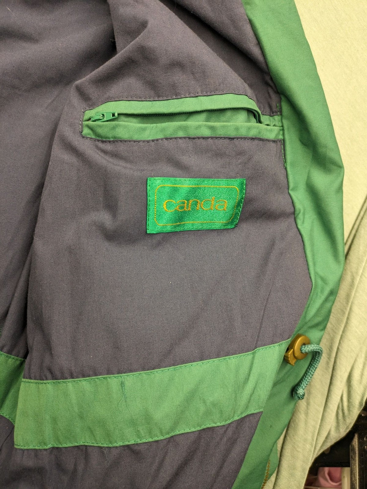 Canda green parka coat with dark lining, multiple pockets, and Micro Membrane technology.
