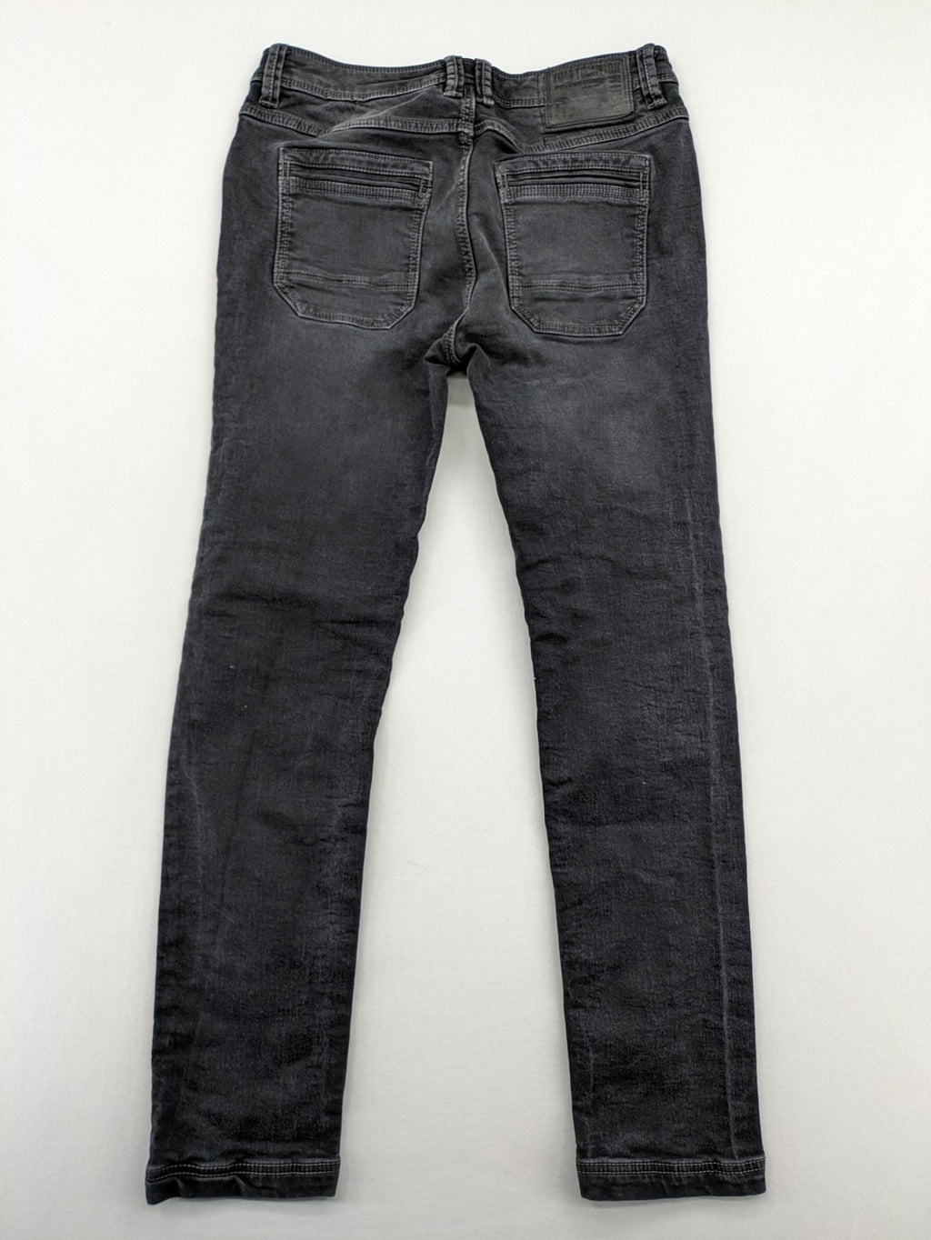 Tom Tompson grey slim tapered jeans with washed denim finish and subtle branding.