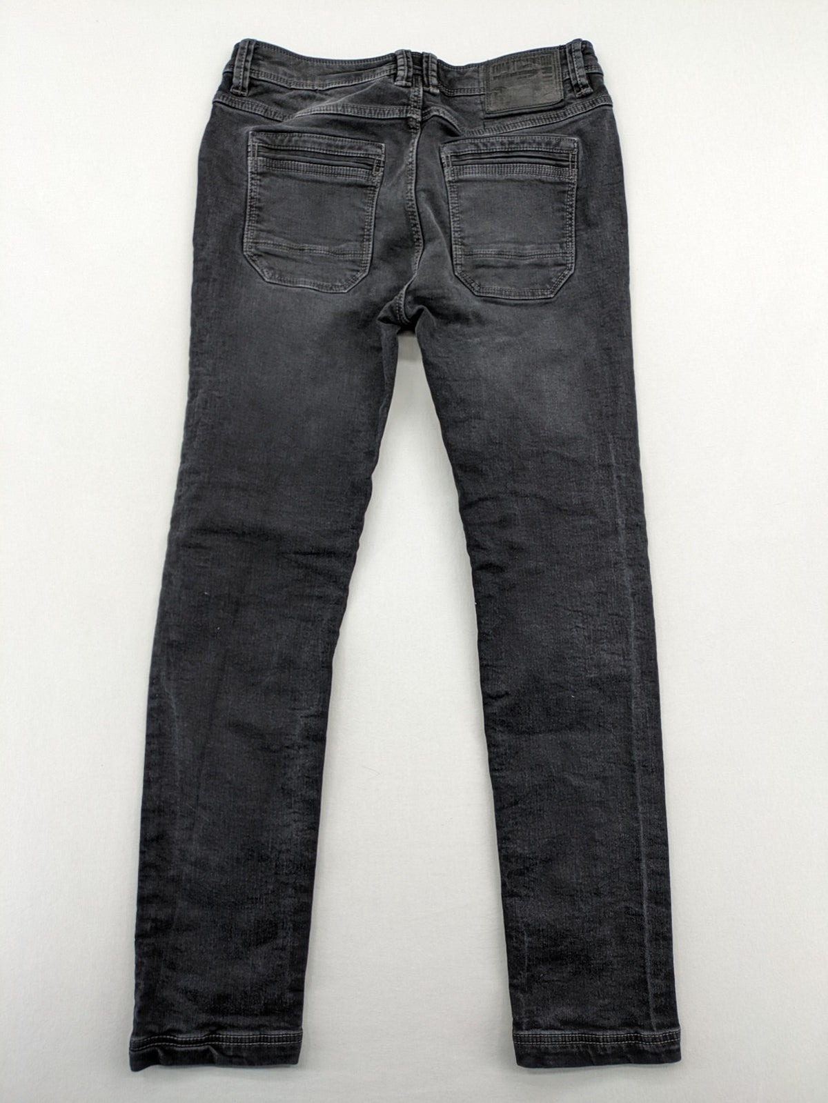 Tom Tompson grey slim tapered jeans with washed denim finish and subtle branding.