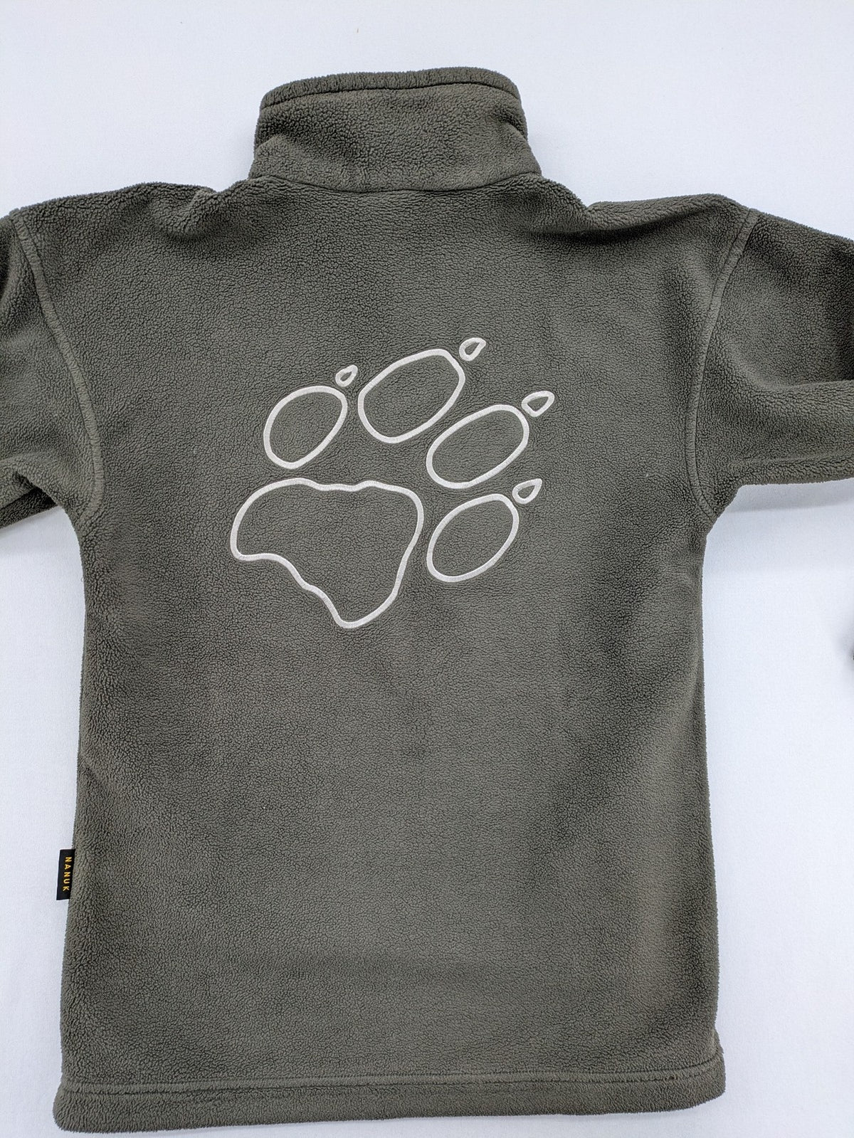 Jack Wolfskin khaki turtle neck jumper with quarter zip and embroidered paw logo.