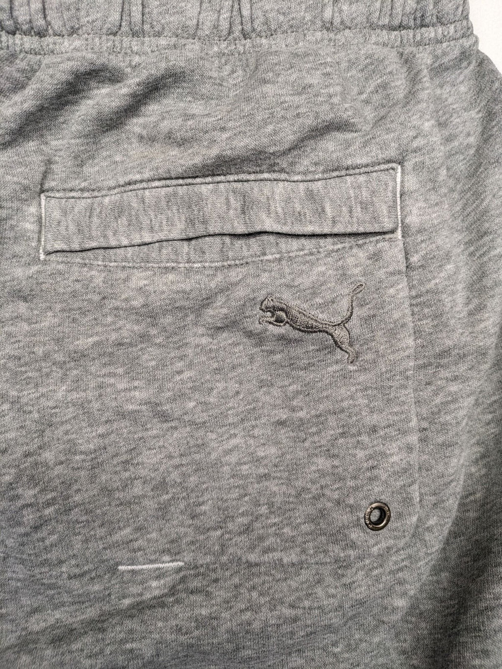 Puma grey sweat shorts with embroidered logo, made from cotton-polyester blend.