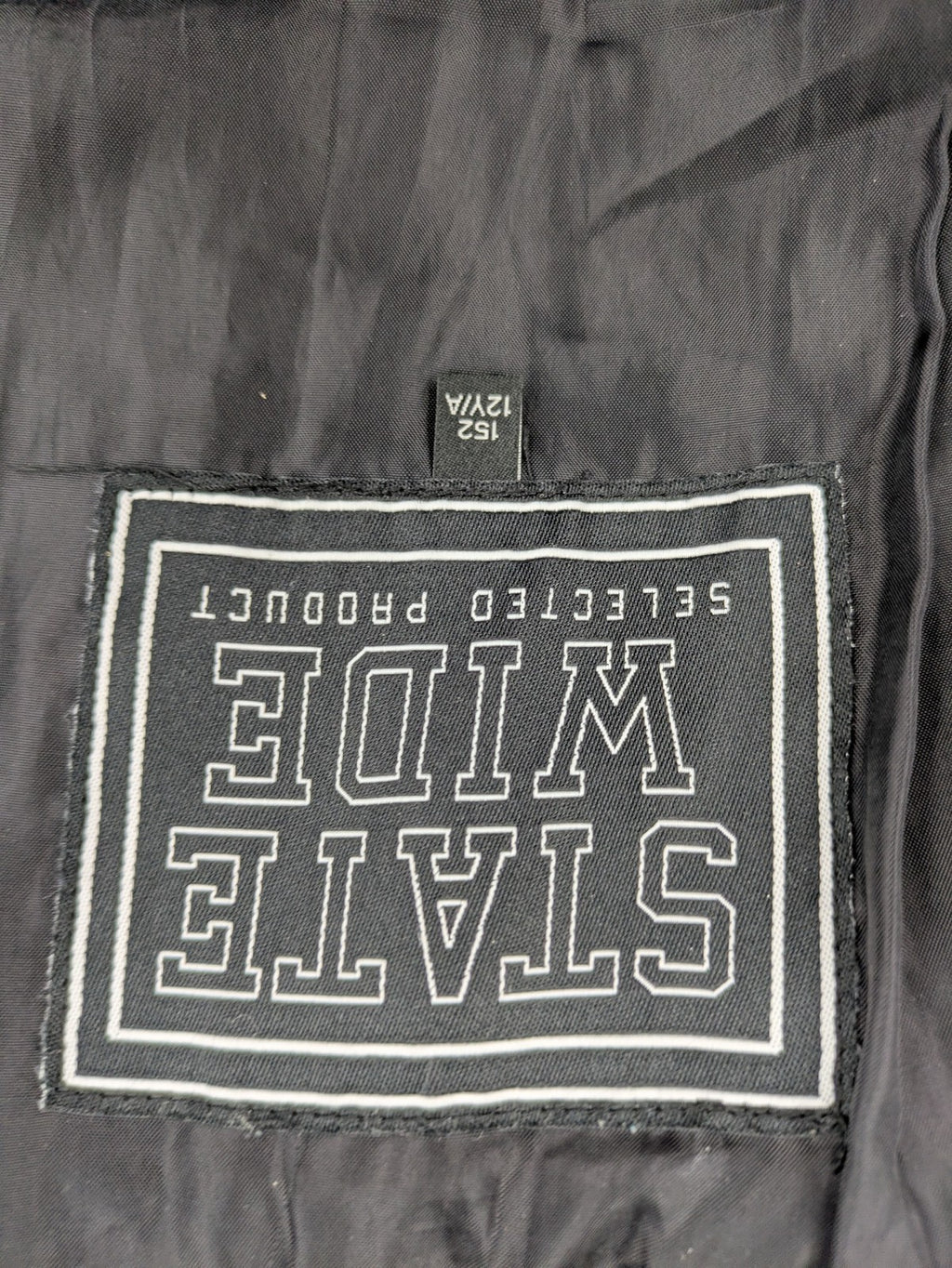 C&A black puffer jacket with NYC83 graphic, hood, and multiple pockets.