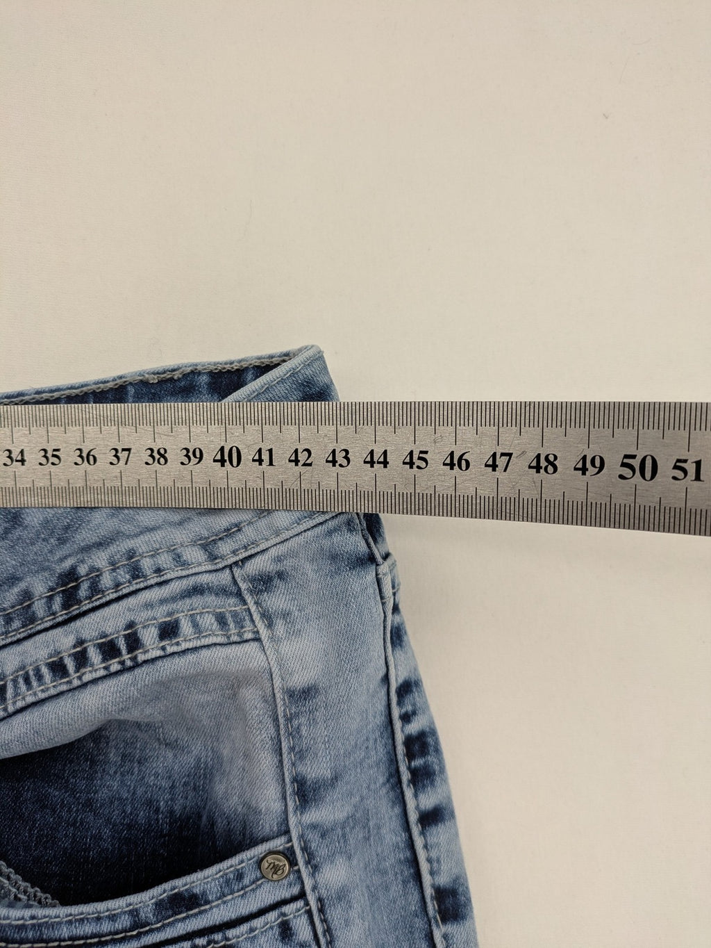 Multiblu blue straight jeans slim fit with decorative front zippers and light wash.
