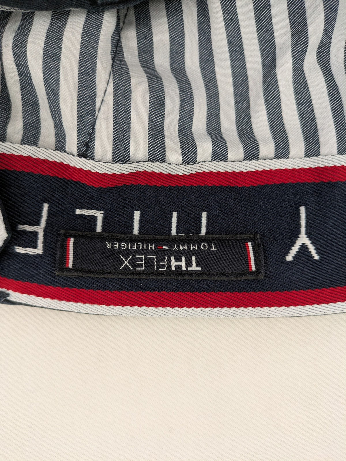 Tommy Hilfiger grey chino pants with TH-Flex stretch technology and classic straight fit design.