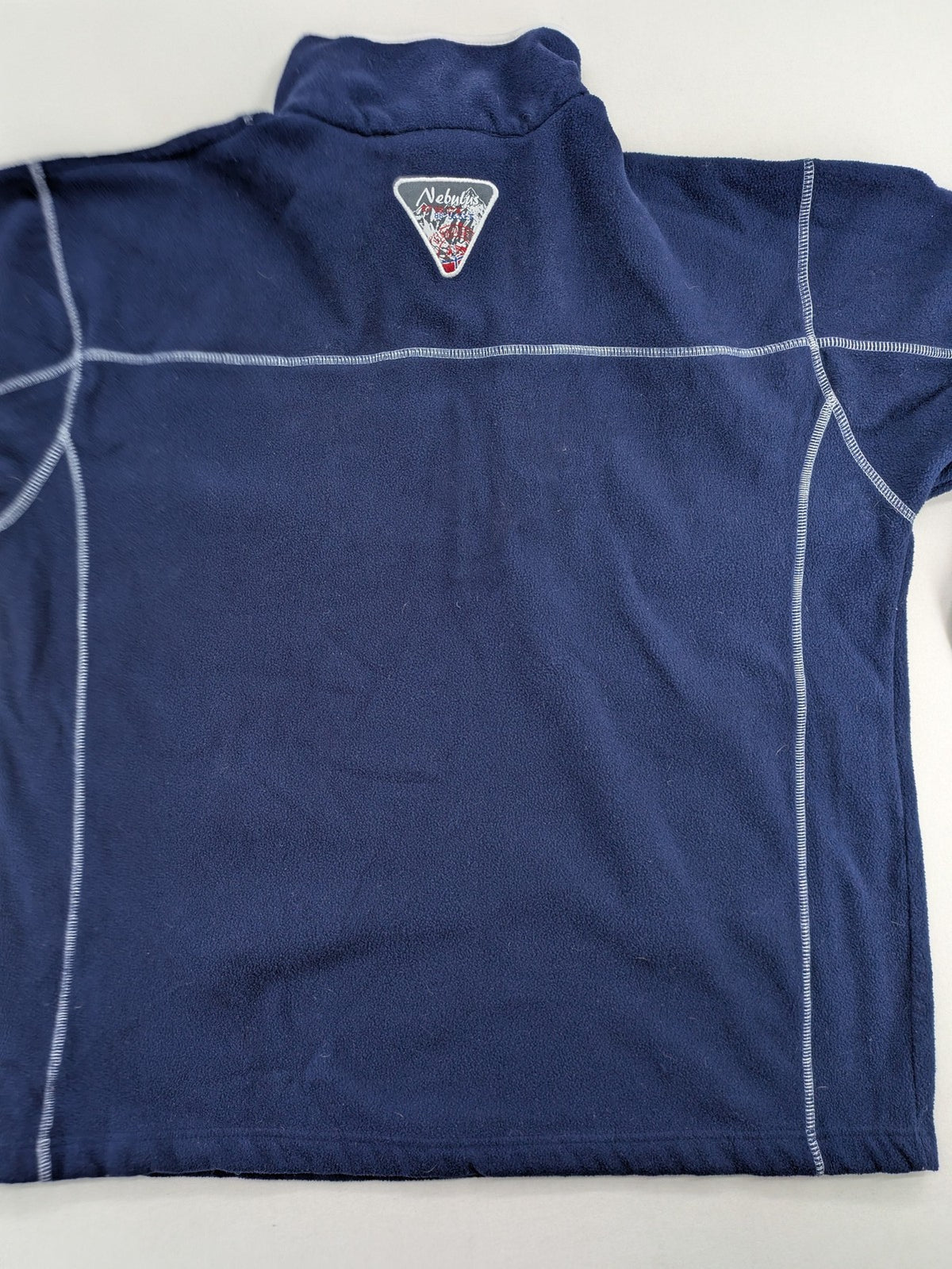 Nebulus navy turtle neck jumper with graphic print collar and "Himalaya Expedition" patch.