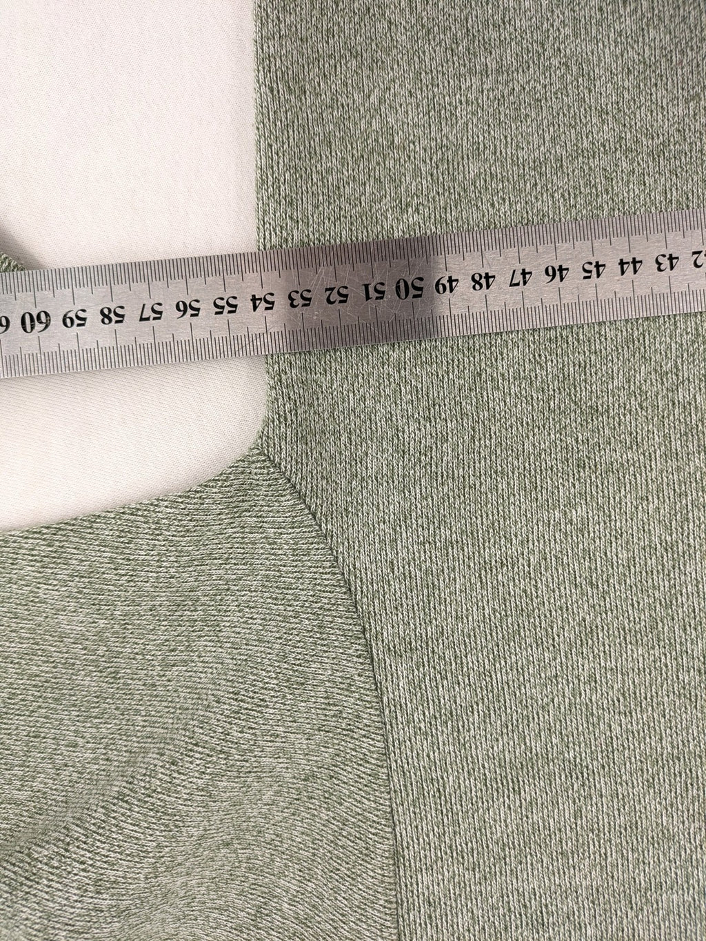 NOSCH knit jumper grey textured fabric with embroidered logo and subtle rhinestone accents.