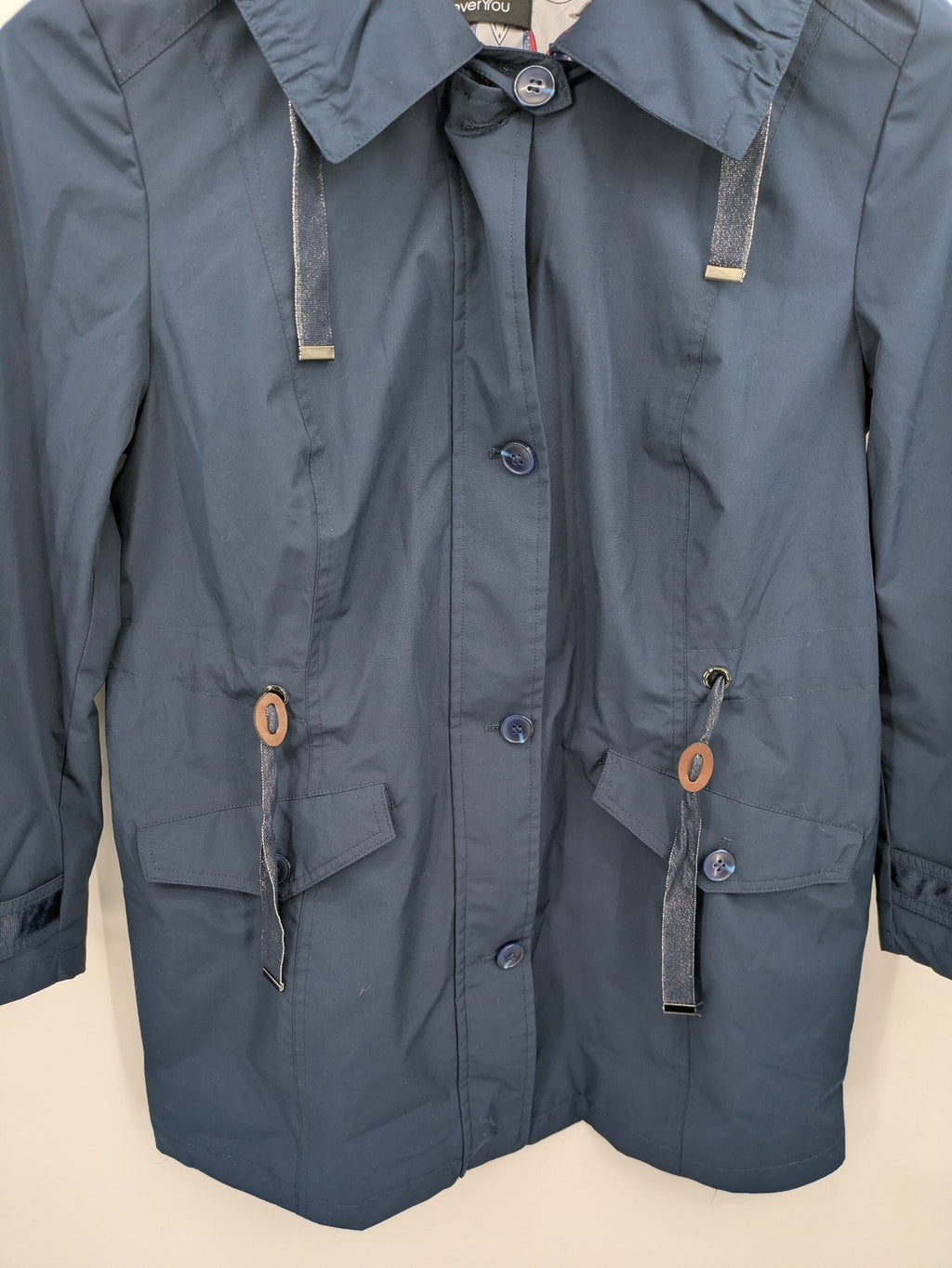 everYou navy parka jacket with hood, adjustable drawstring, patterned lining, button closure.