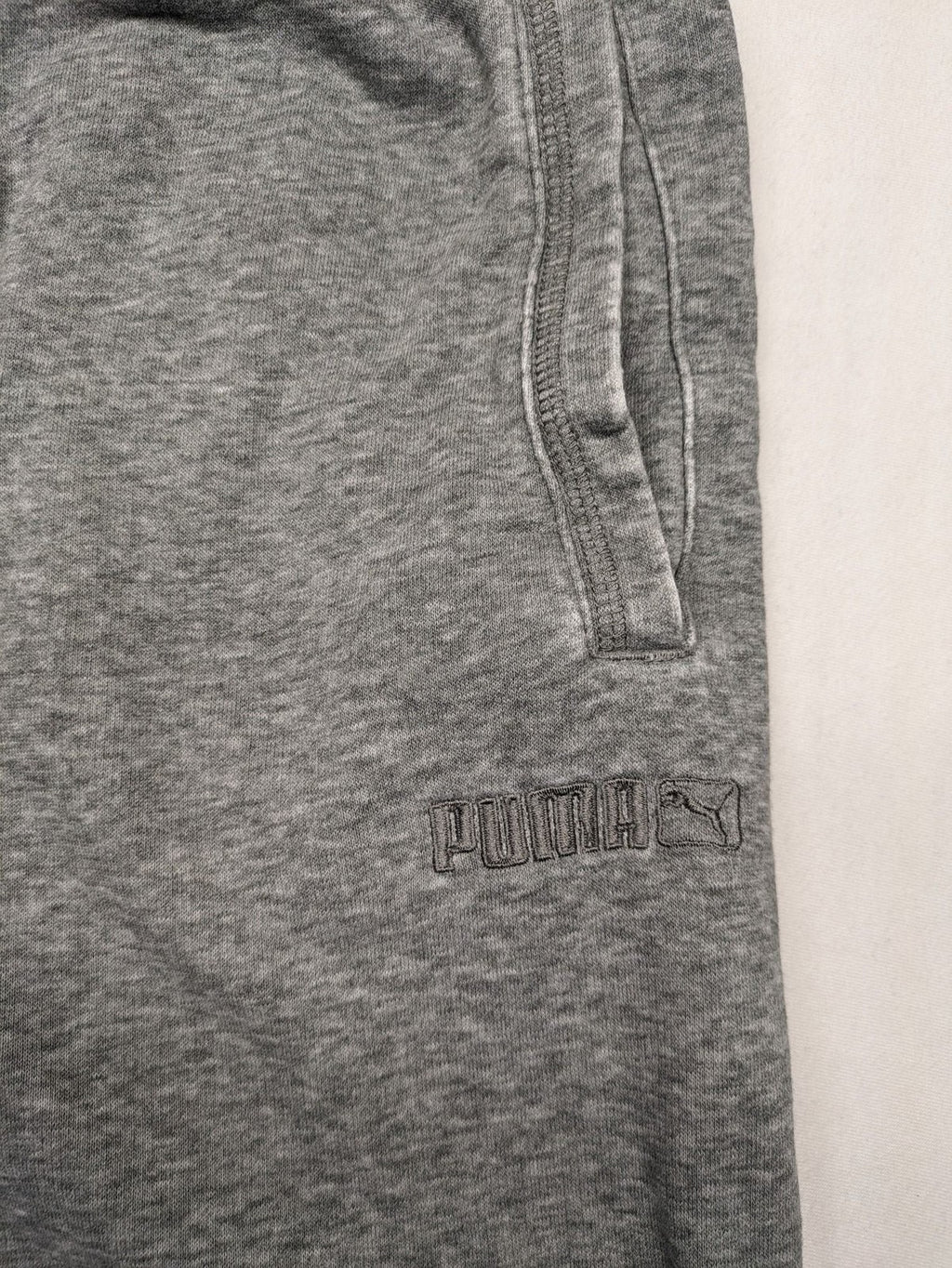 Puma grey sweat shorts with embroidered logo, made from cotton-polyester blend.