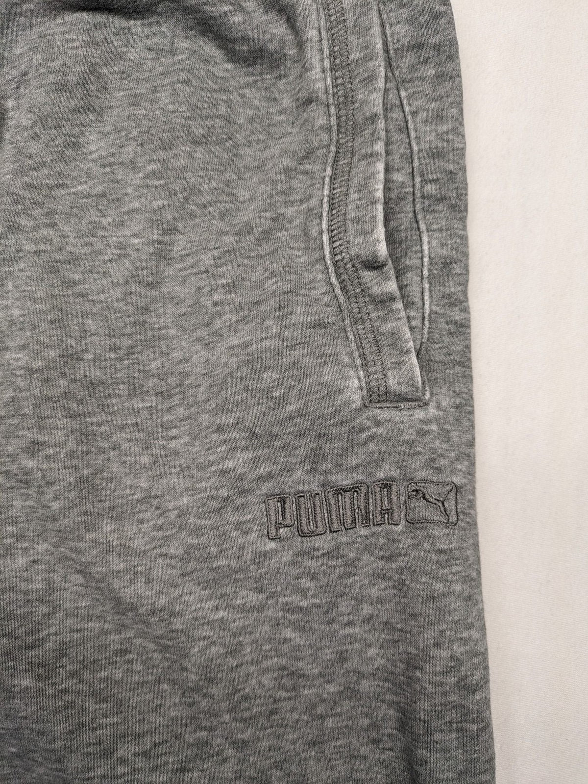 Puma grey sweat shorts with embroidered logo, made from cotton-polyester blend.