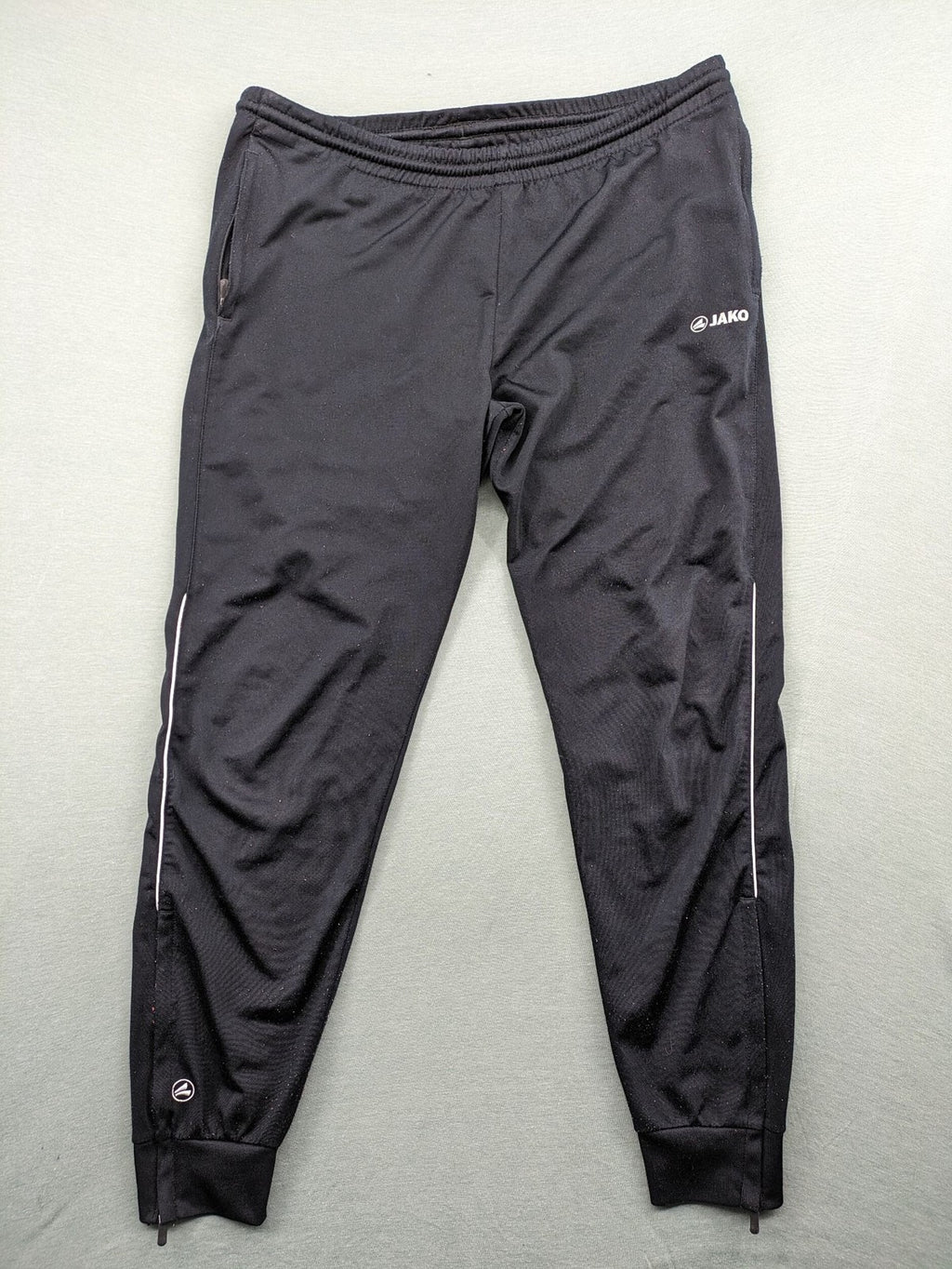 Jako black training pants size L with zippered pockets and elastic waistband.