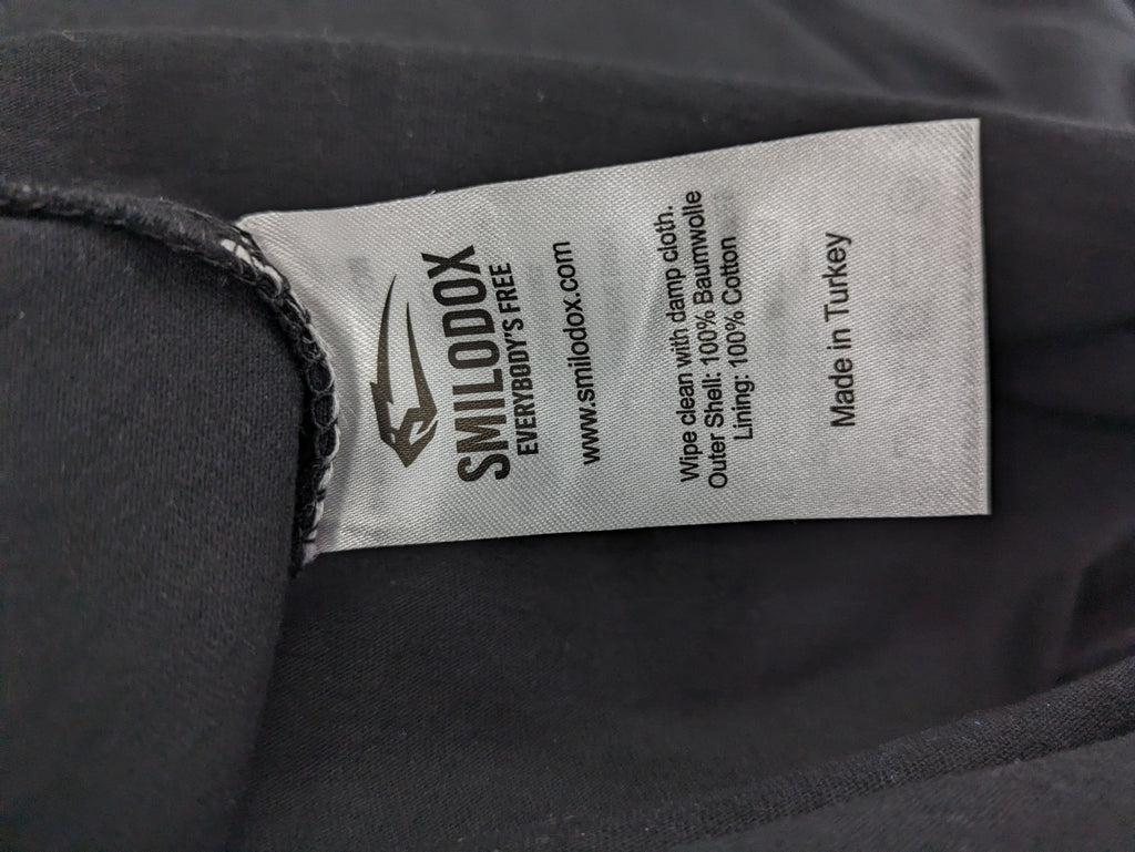 Smilodox black T-shirt minimalist design with subtle brand patch, 100% cotton.