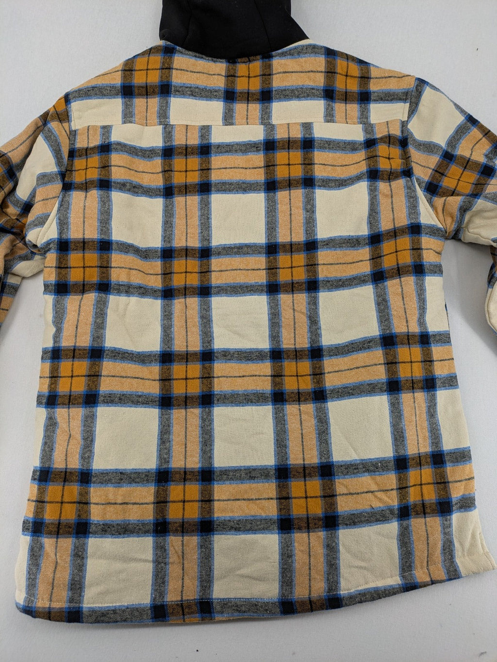 Bench cream flannel jacket with check pattern, black hood, and button placket.