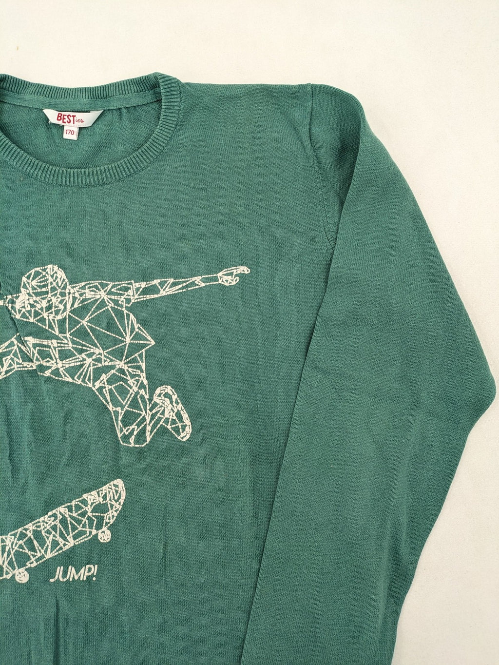 BESTies green turtle neck jumper with white skateboard graphic and ribbed cuffs.