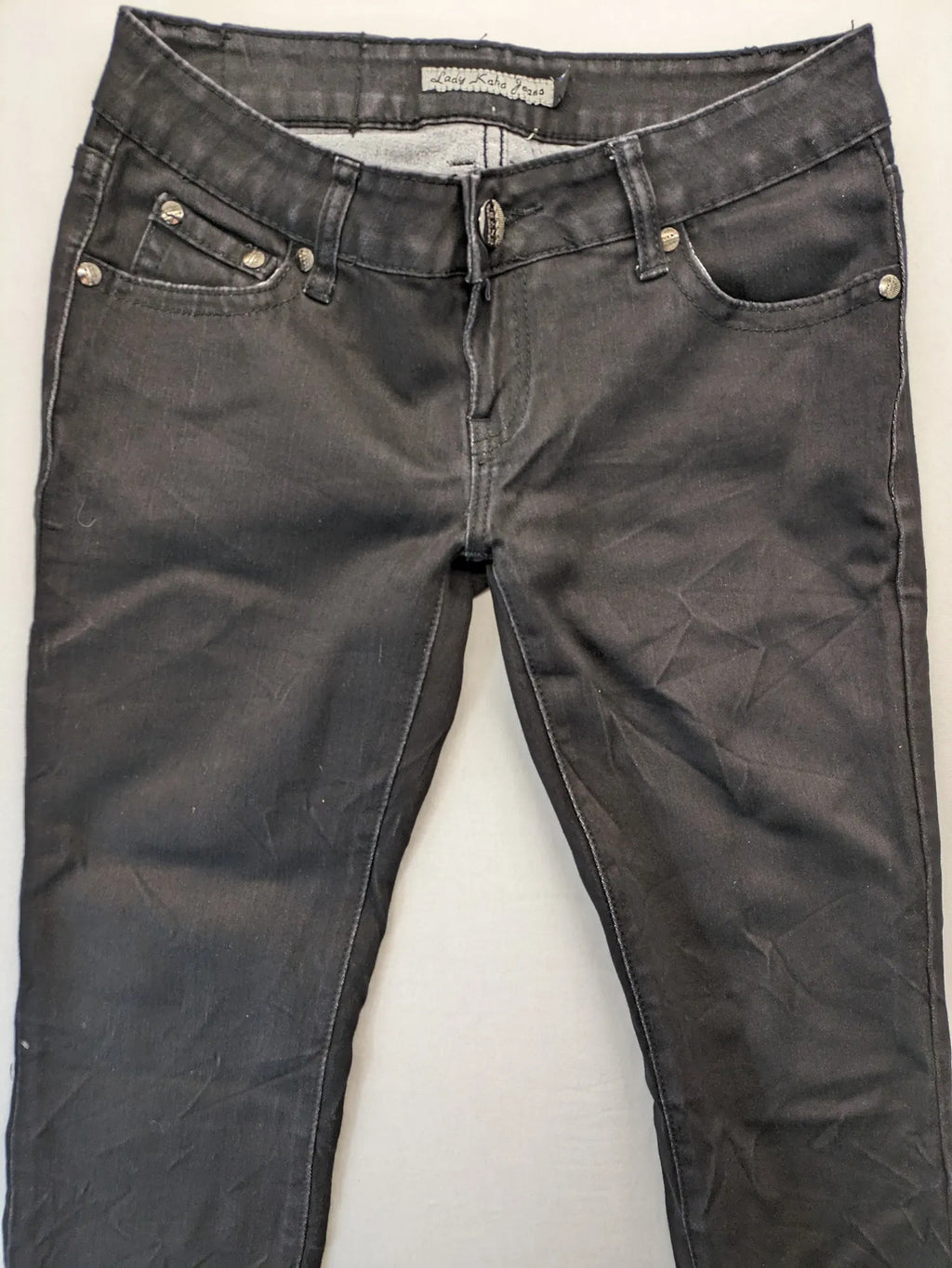 L & K Kaha black straight jeans with rhinestone logo patch and classic 5-pocket design.