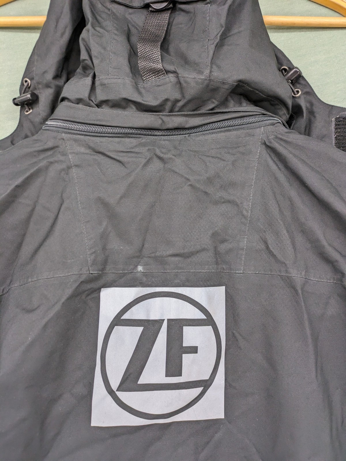 Stormtech black waterproof jacket with ZF logo, H2Xtreme technology, front zipper, and hood.