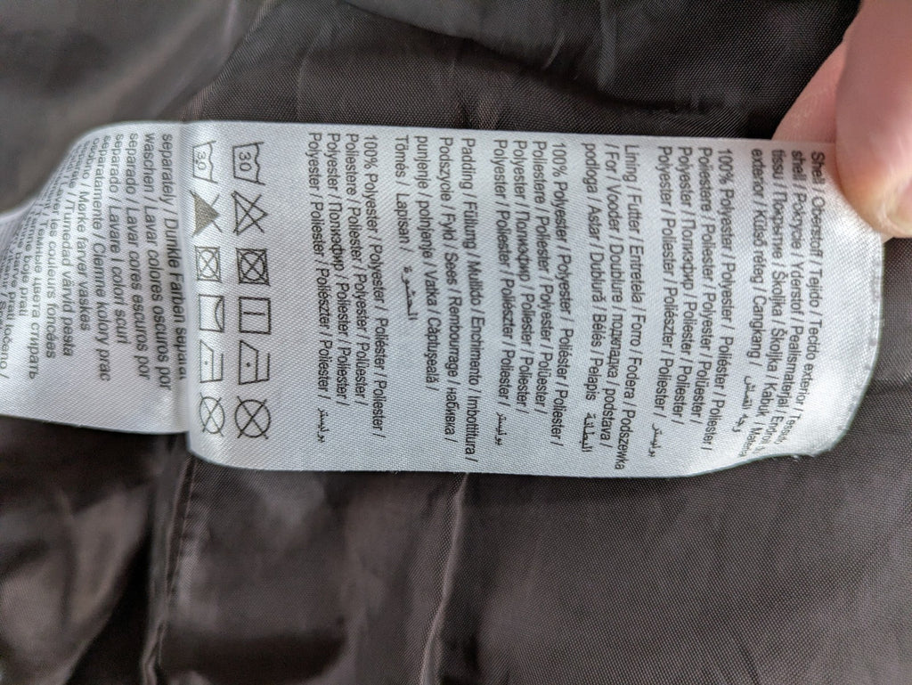 Vero Moda grey quilted jacket with high funnel neck and zippered pockets.
