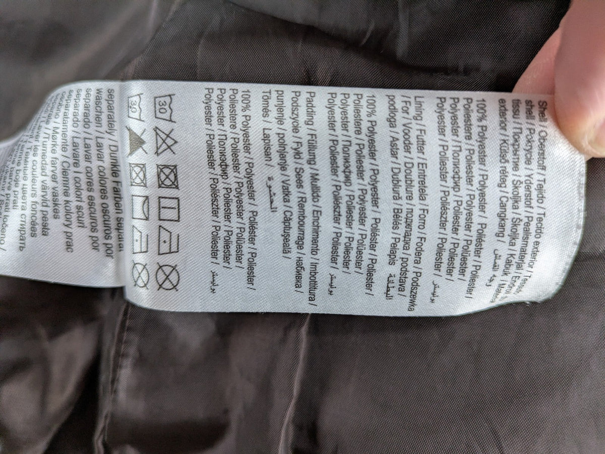 Vero Moda grey quilted jacket with high funnel neck and zippered pockets.